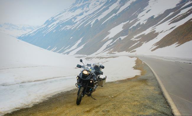 Motocykl stojący w górach zimą